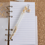 Λευκό-χρυσό σημειωματάριο μεσαίο υγρό γυαλί